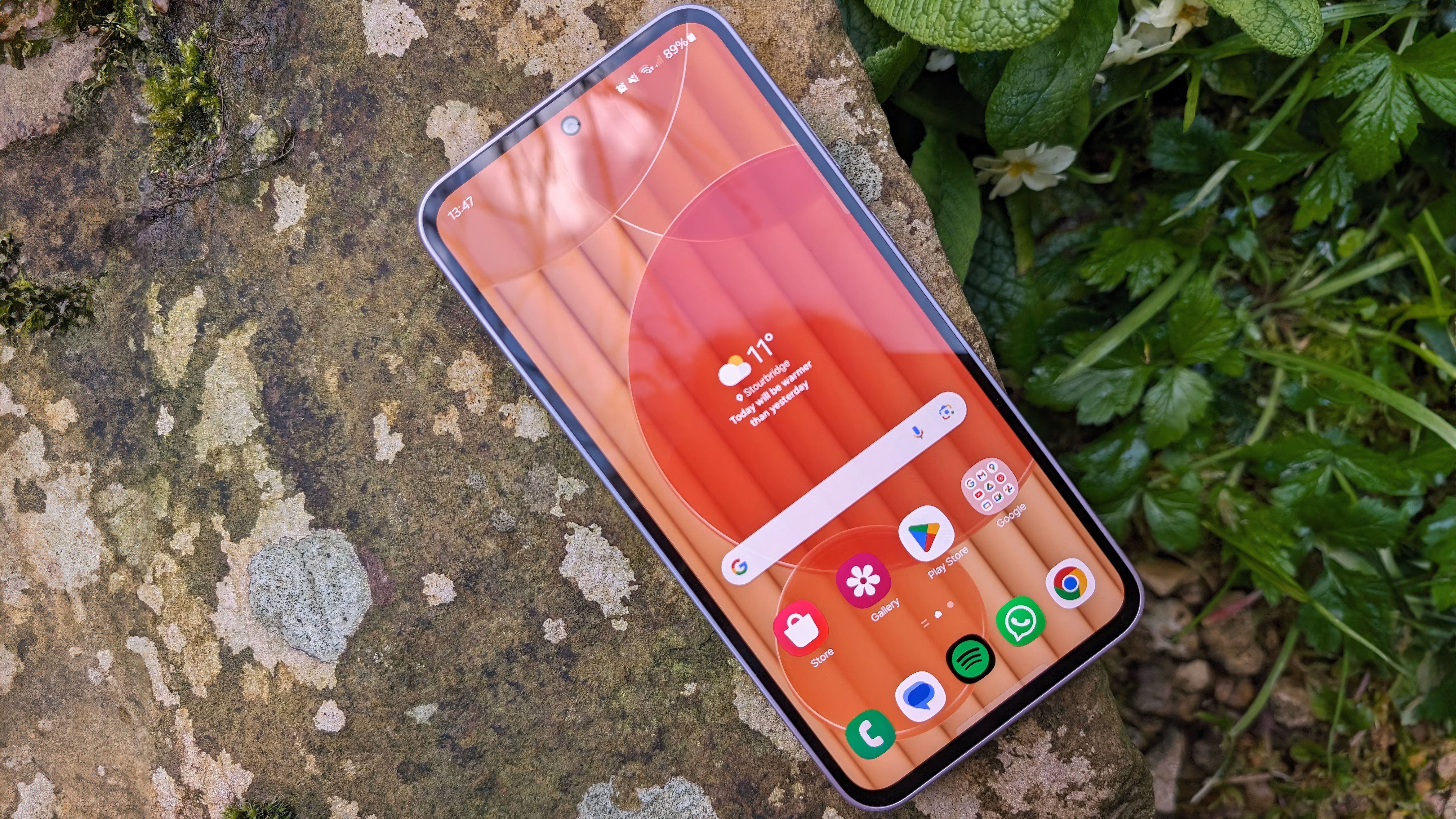 A Samsung Galaxy A35 rest atop a stone