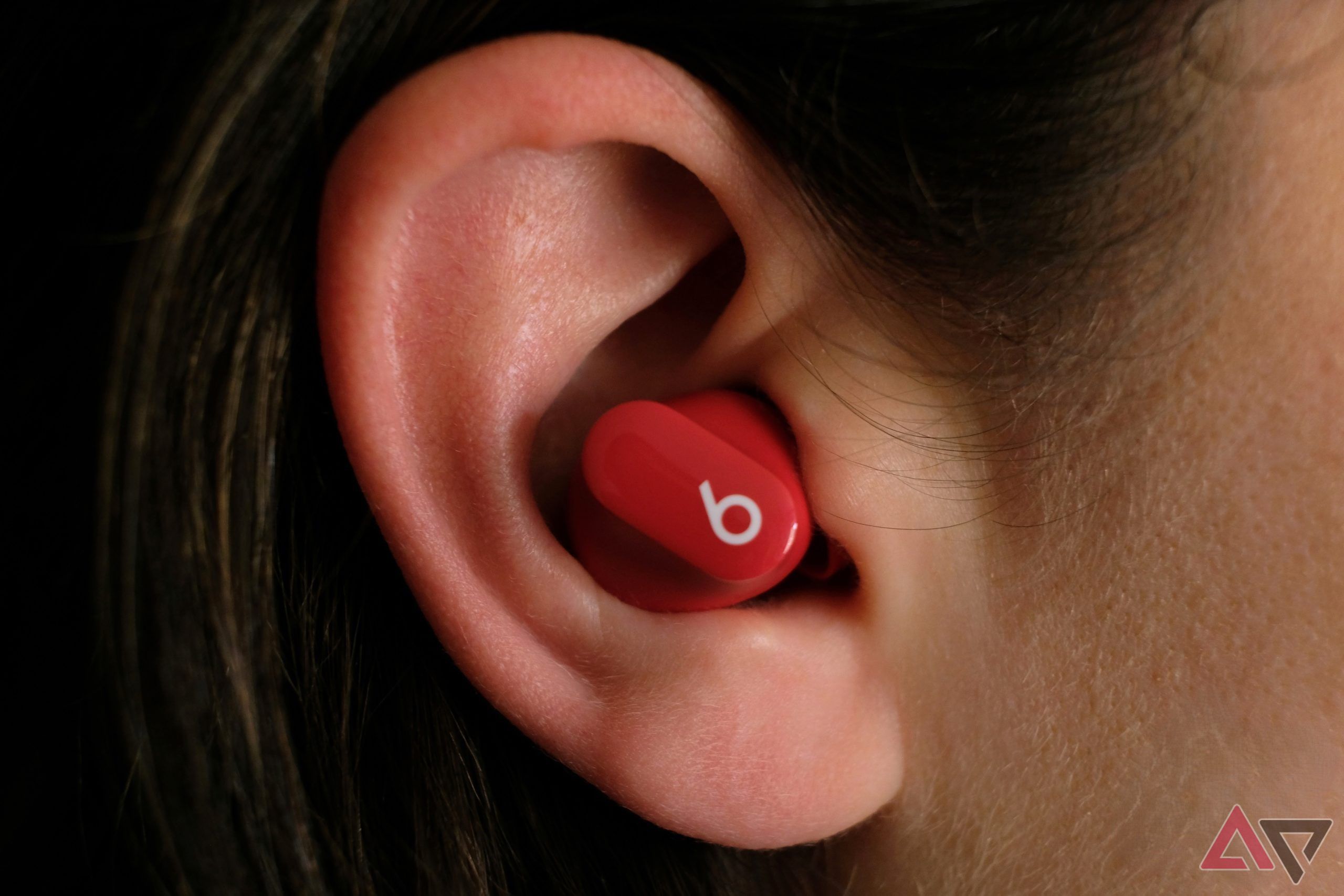 beats studio buds sitting in ear with logo showing