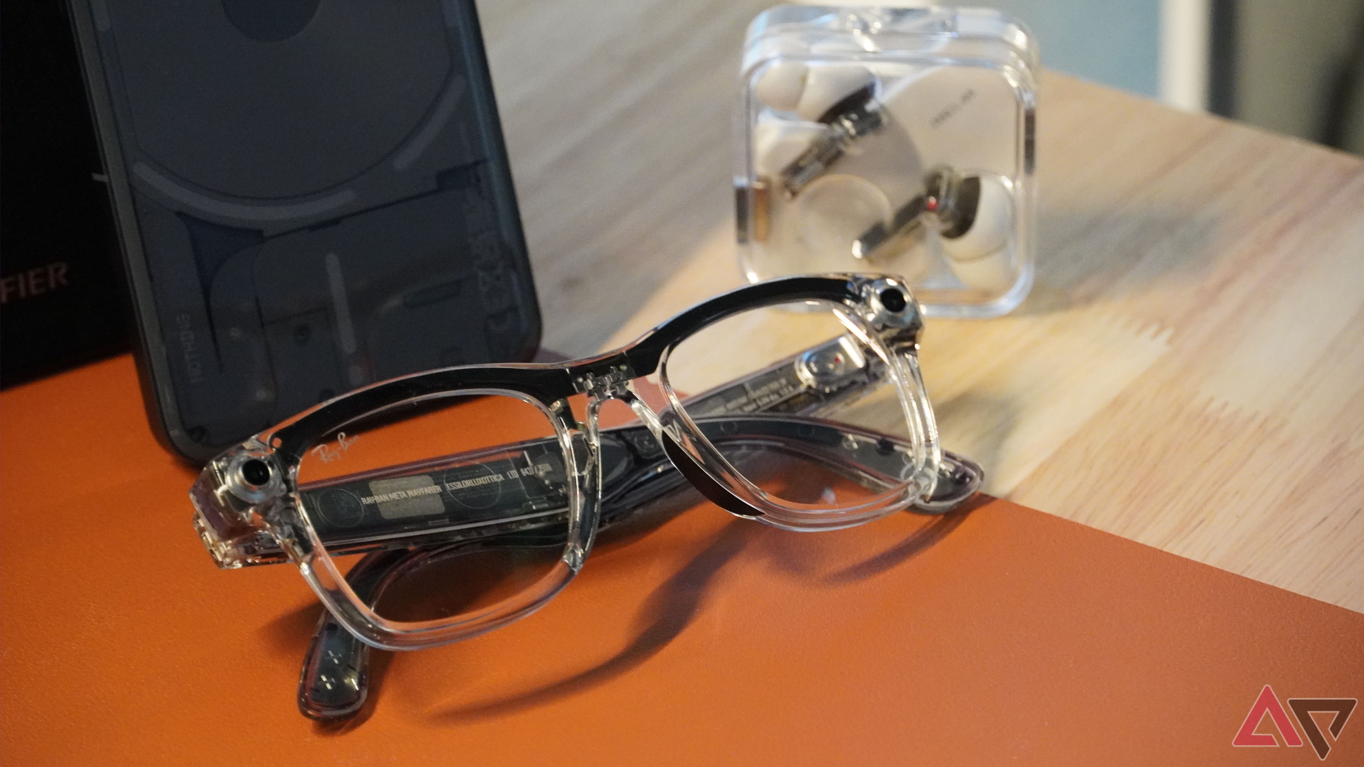 Ray-Ban Meta smart glasses on a desk with other transparent products.