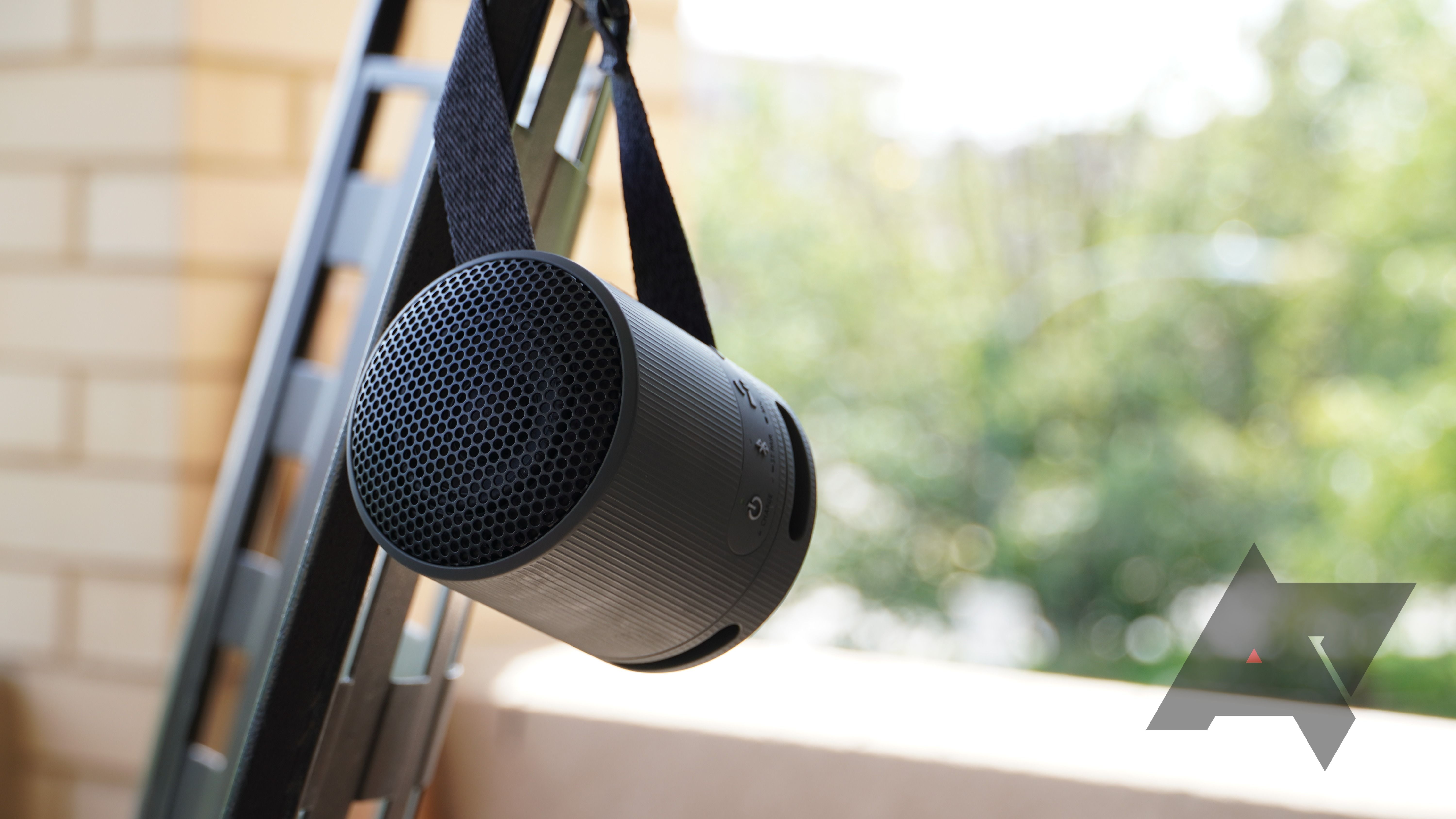 Sony SRS-XB100 Bluetooth speaker hanging on a chair