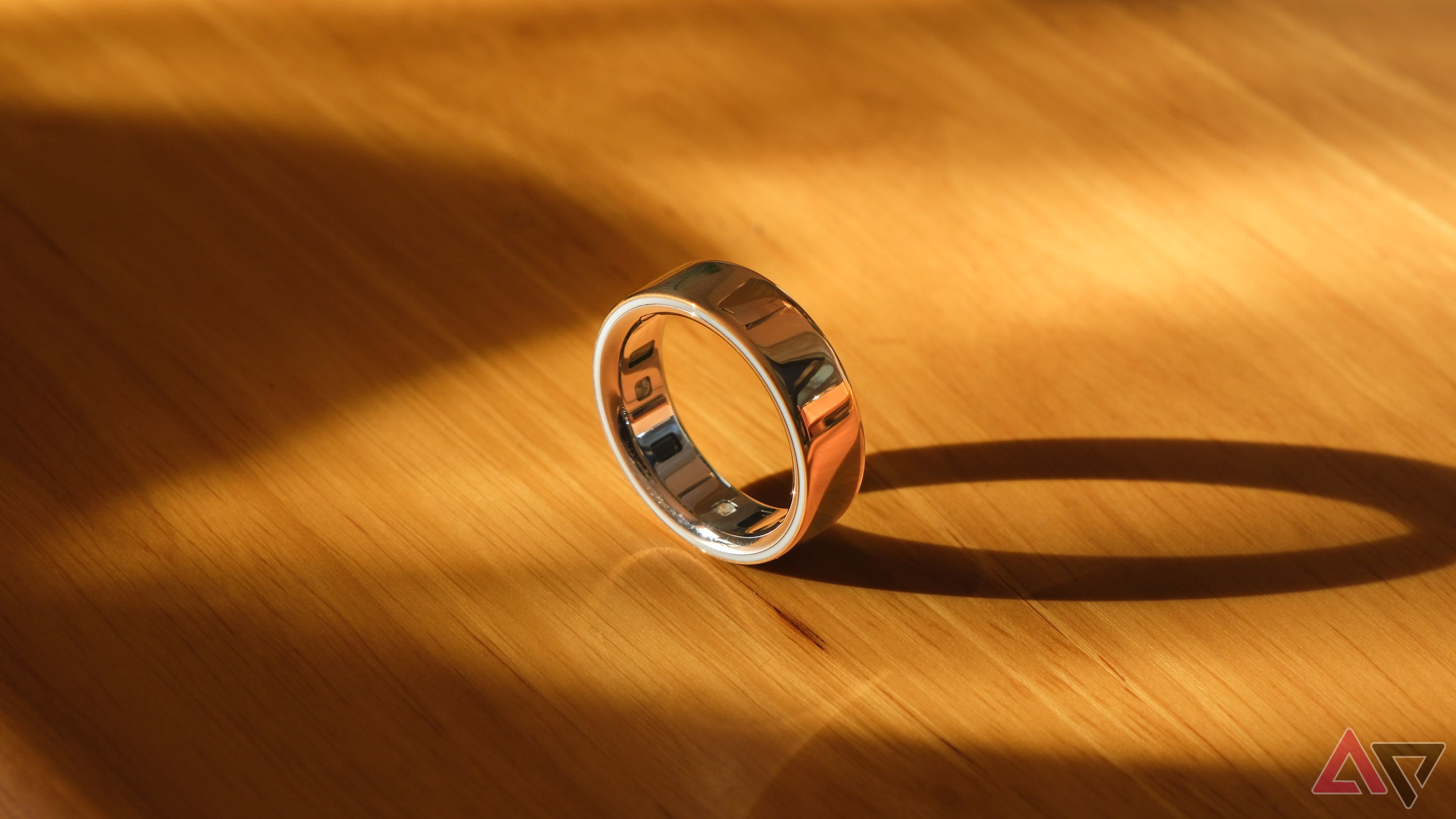A smart ring standing on edge on a desk.