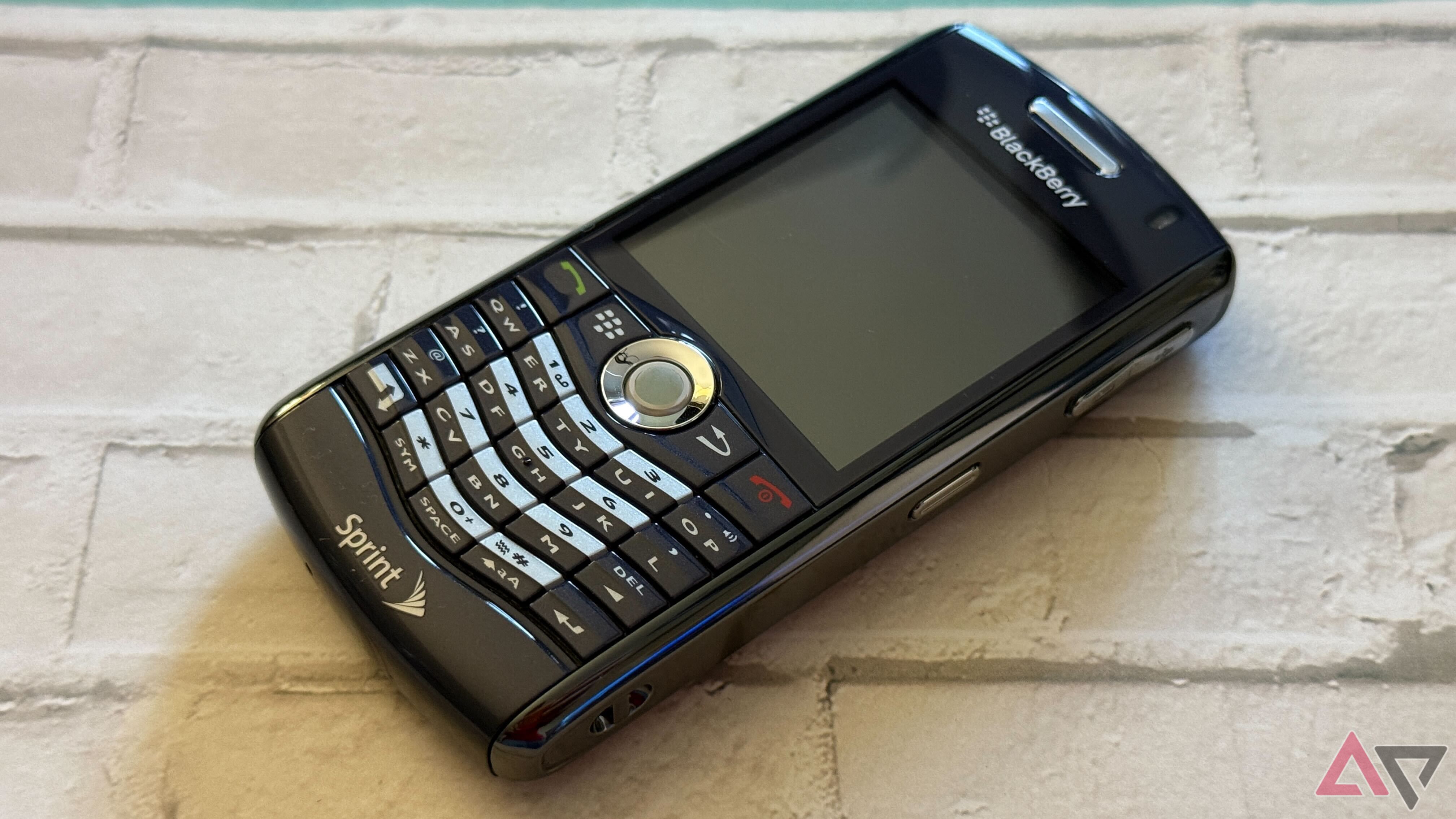 blackberry pearl sitting on bricks with screen off
