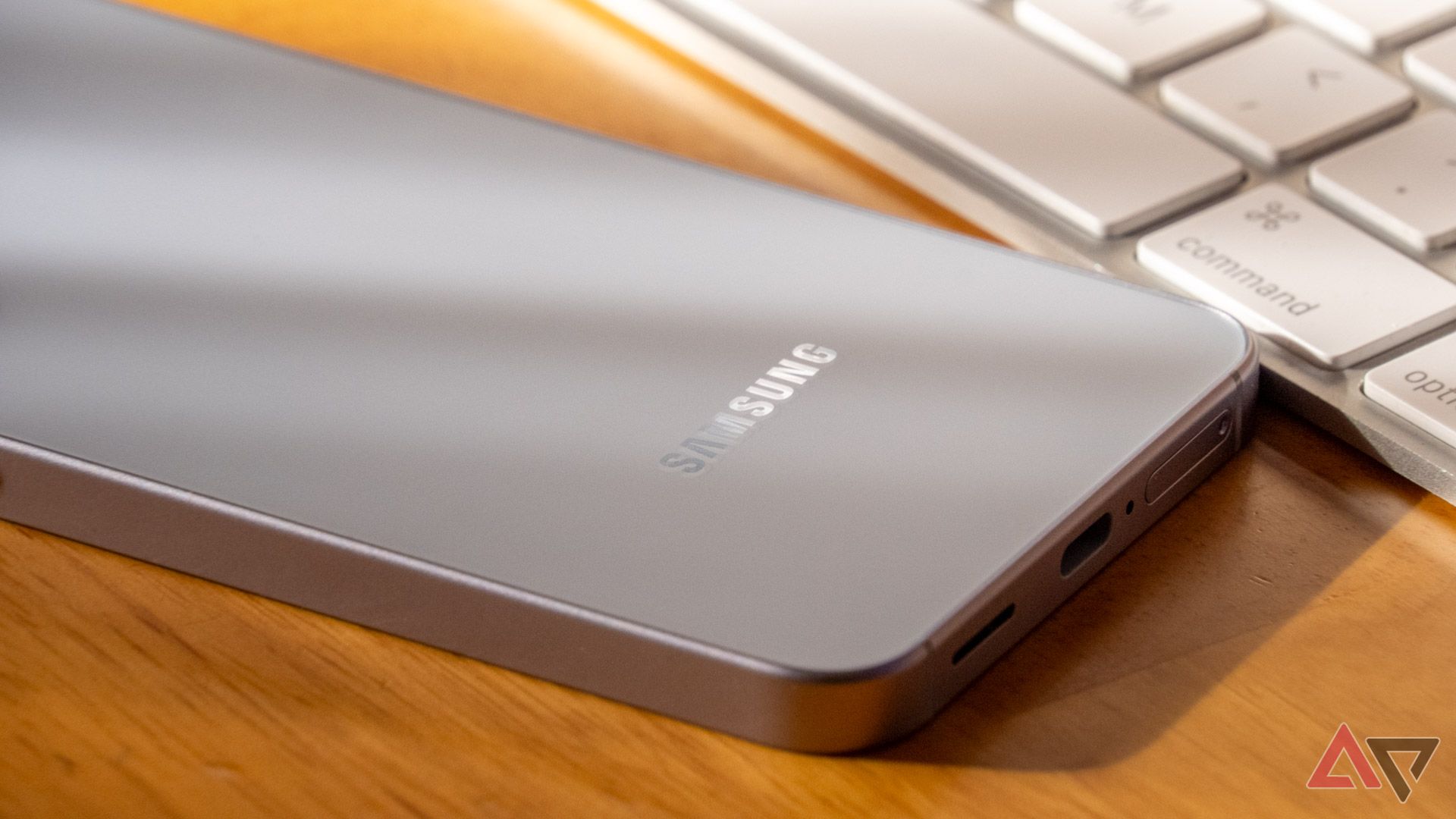Samsung Galaxy S25 lying face down on a desk with the Samsung logo visible