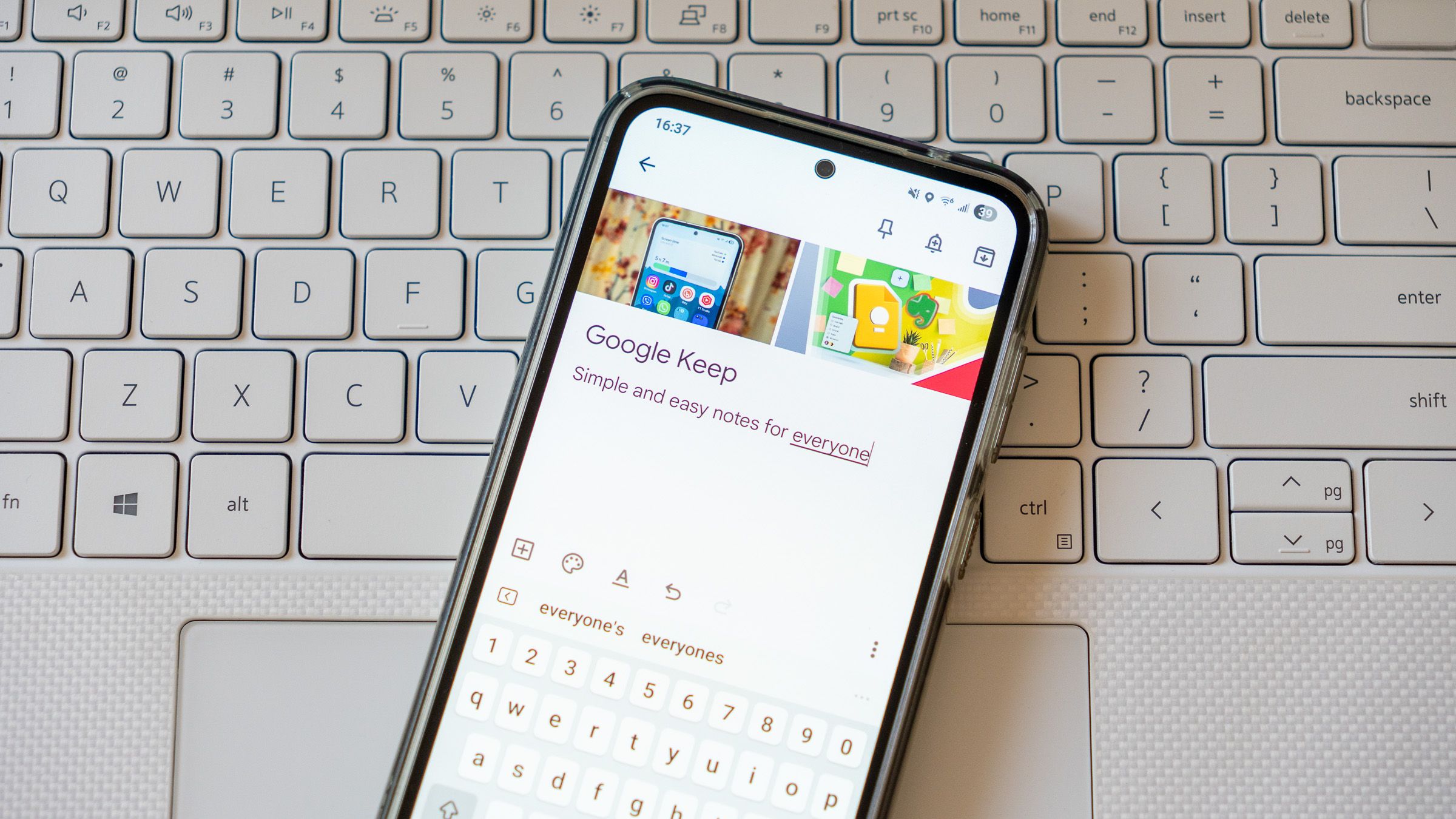 a google keep note displayed on a phone on a laptop keyboard