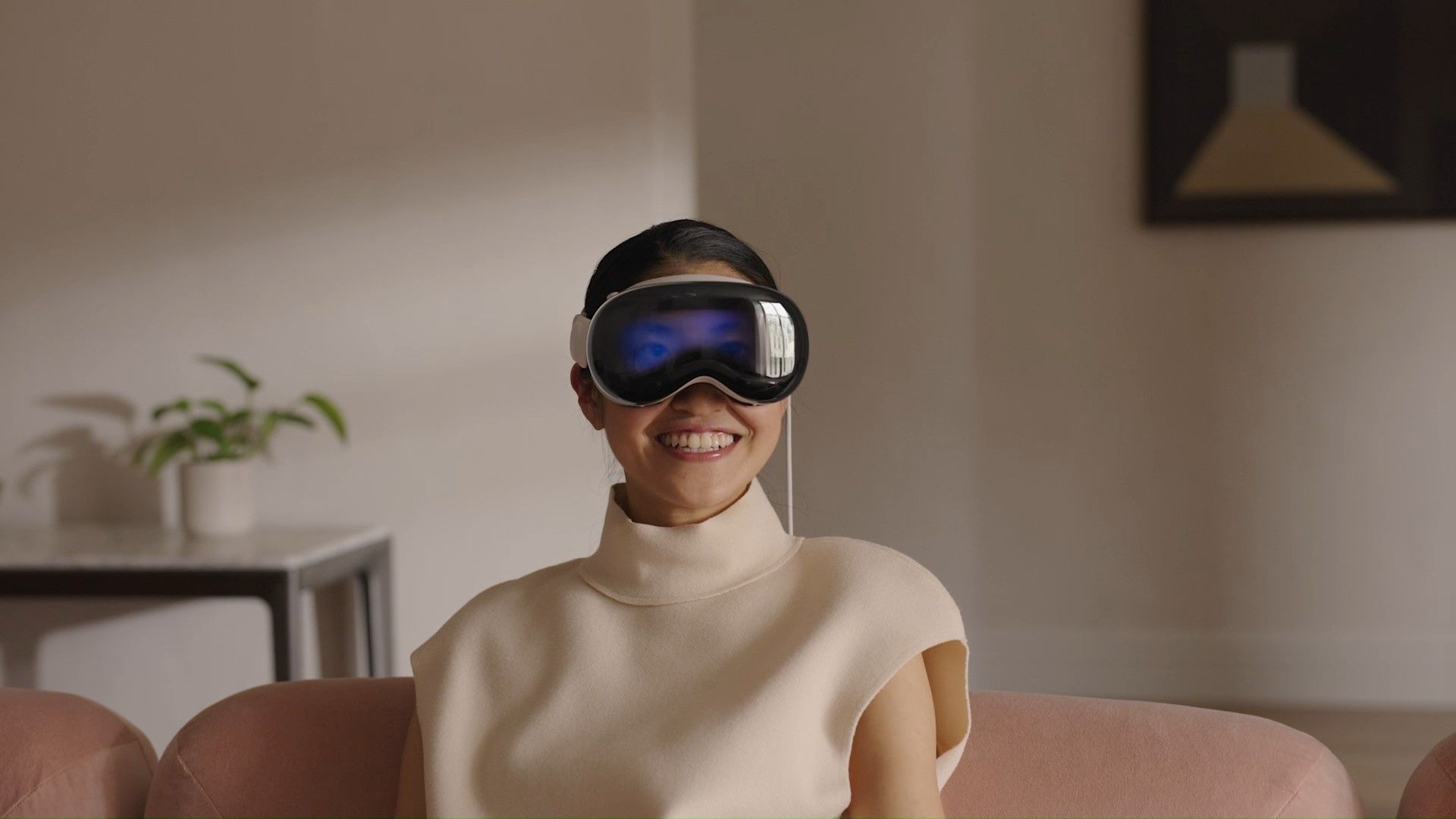 A smiling woman wears Apple's Vision Pro
