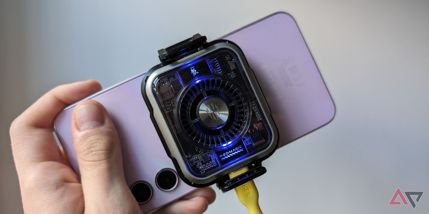 hand holding samsung phone with redmagic cooler attached