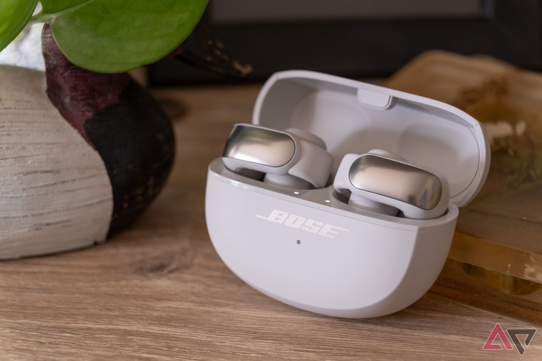 The Bose Ultra Open Earbuds in their open charging case