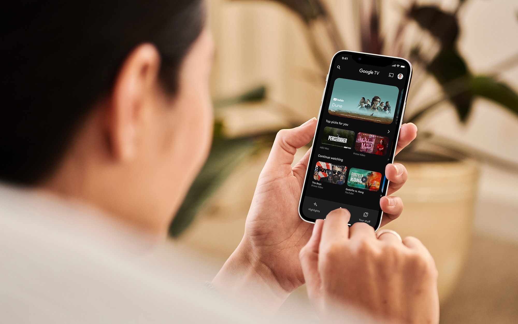 A man watching google TV on his smartphone