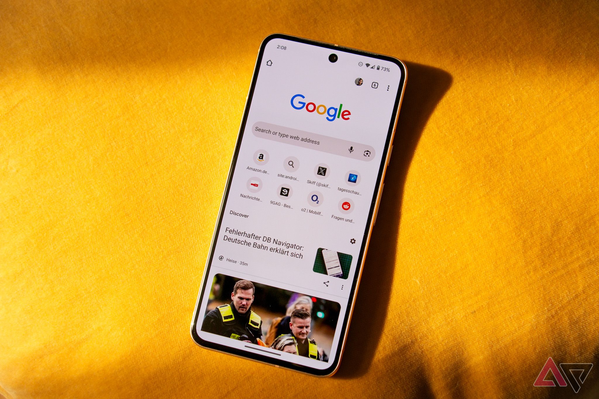 Google Pixel 8 on a bright yellow fabric with Google Chrome open