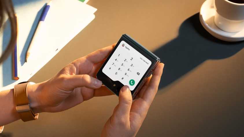A man using his smartphone with a screen time chart from Google's Digital Wellbeing displayed beside him.