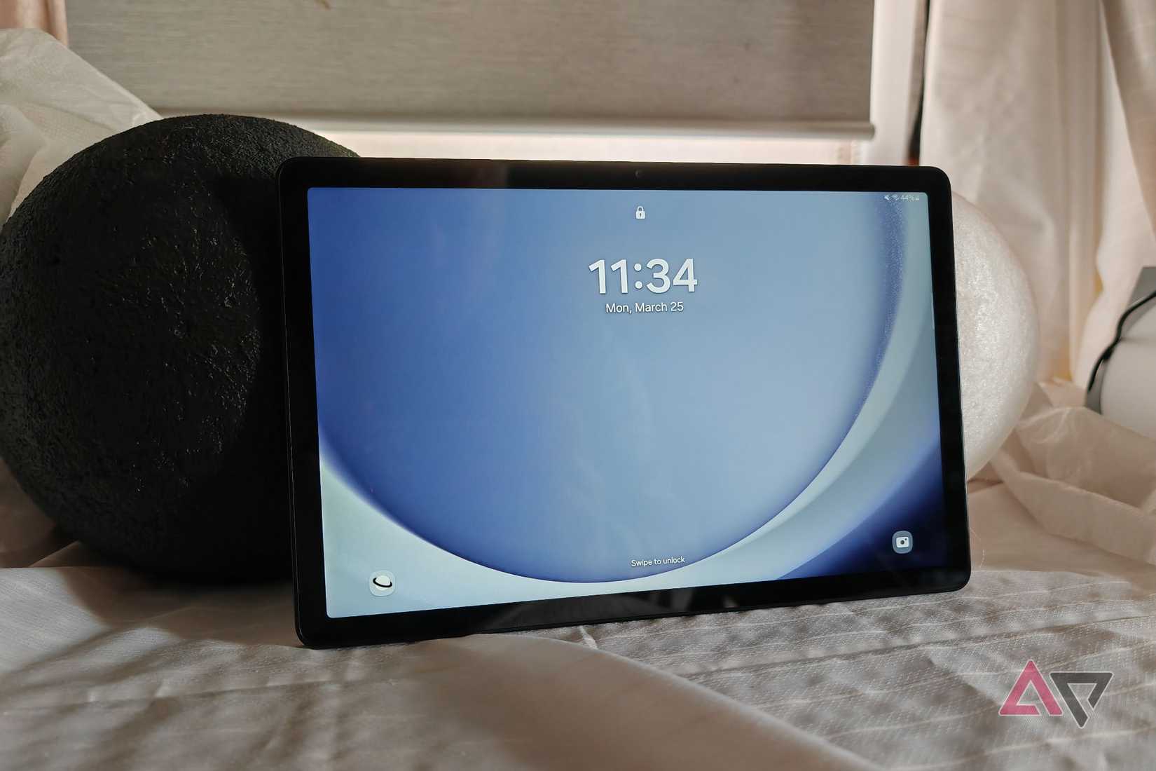 A smartphone screen displaying a glowing app icon with a star-like design, set against a soft blue, cloud-like background.