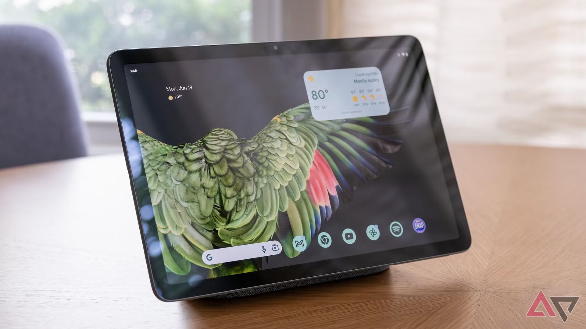 The Pixel Tablet sitting on its dock on a table.