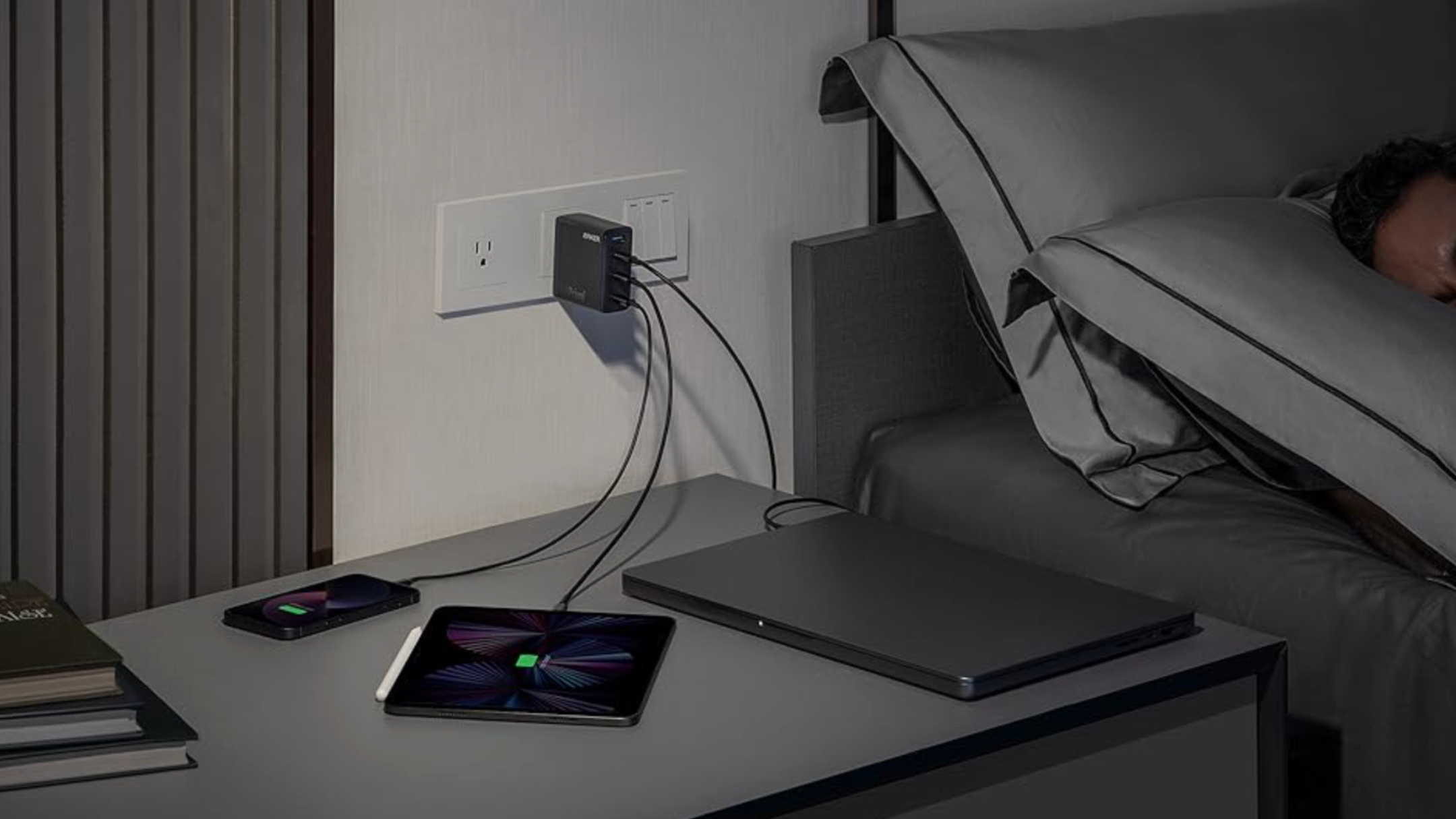 Anker 747 charger plugged into the wall and three devices