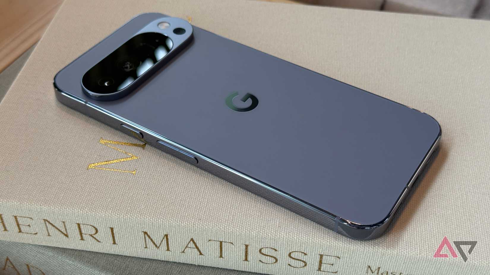 Google Pixel 8 Pro laying next to a fake plant and a plushie