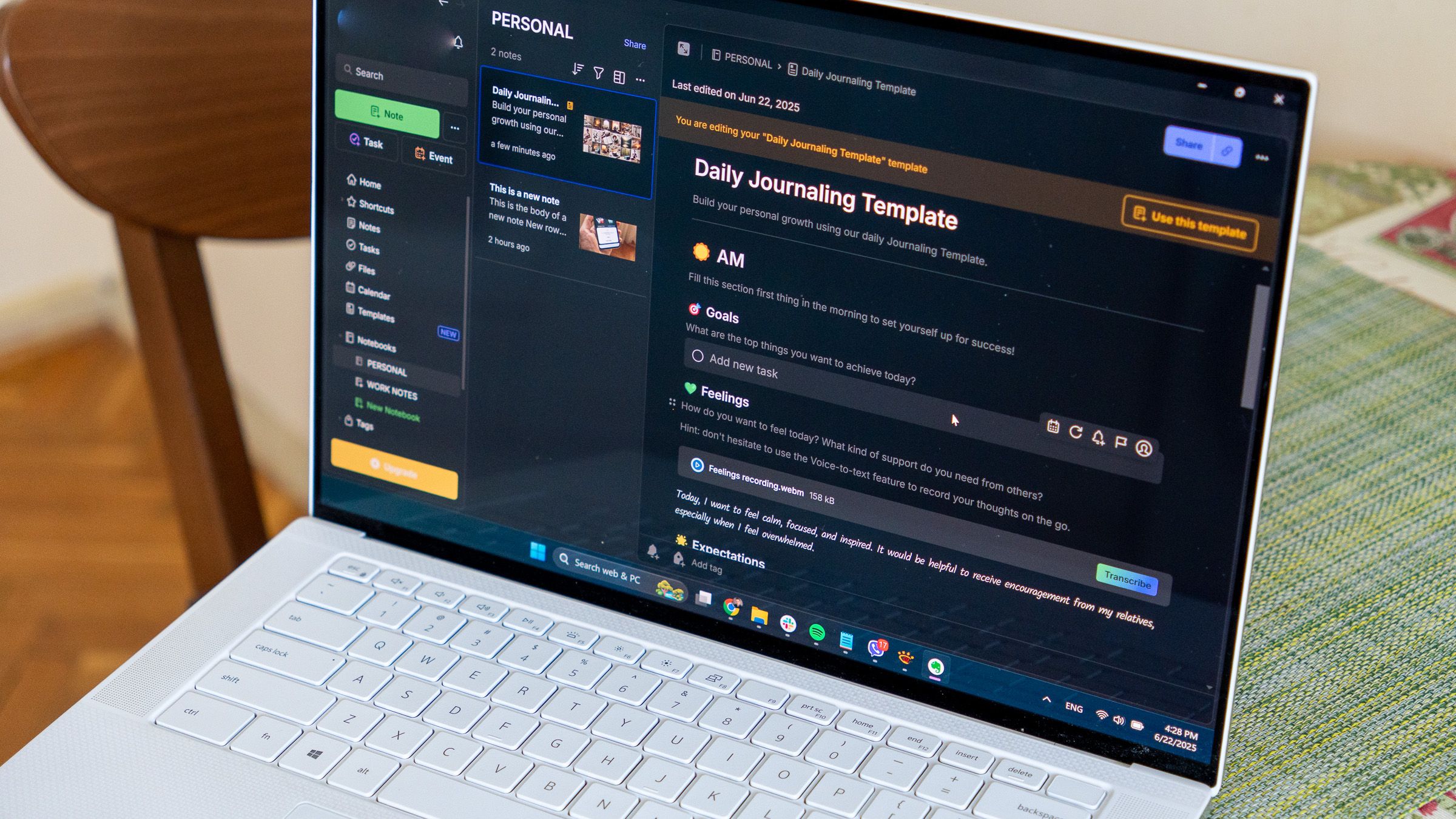 a laptop on a table displaying the evernote desktop app