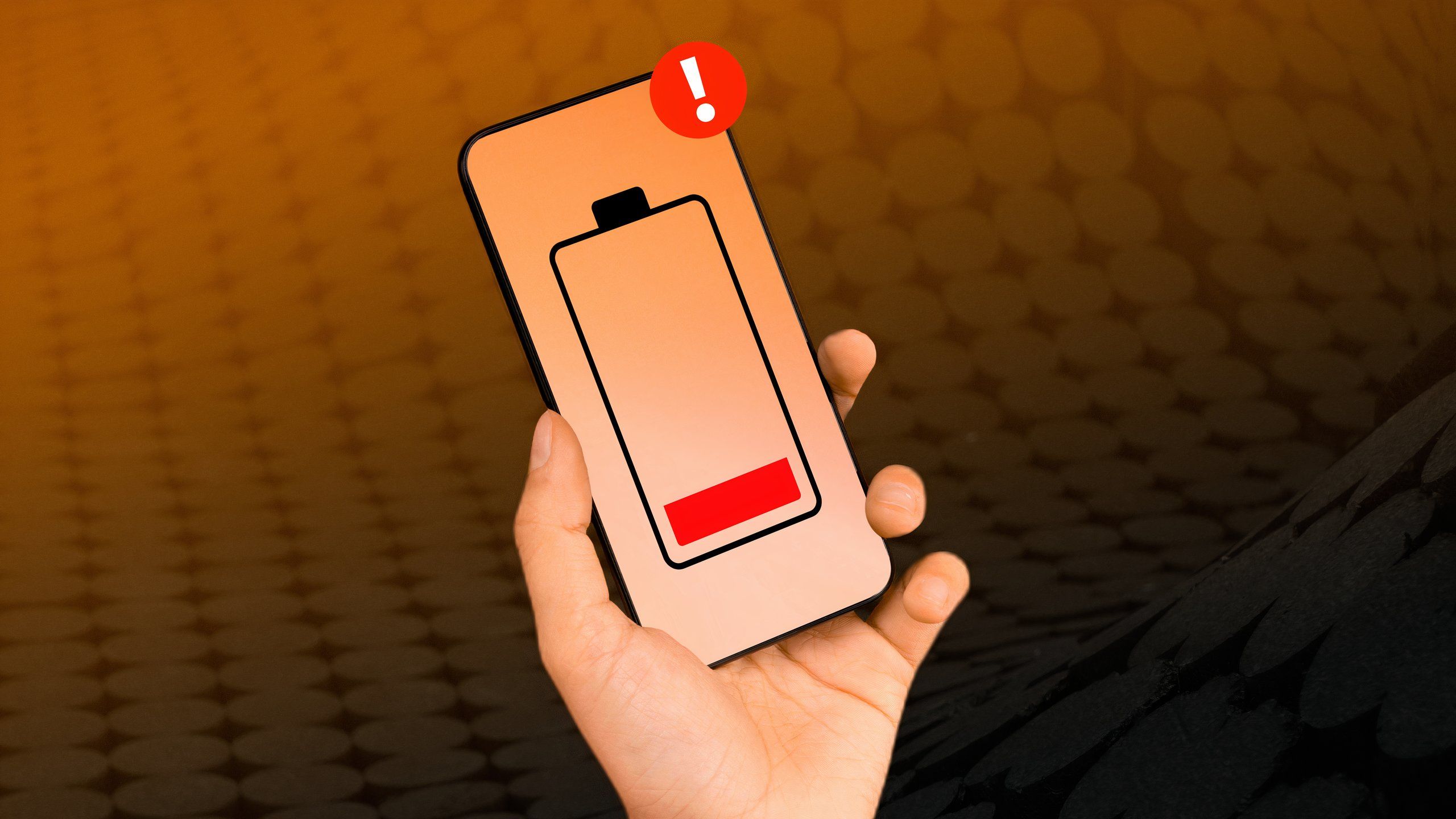 The Google Drive logo on a smartphone against a yellow and orange background