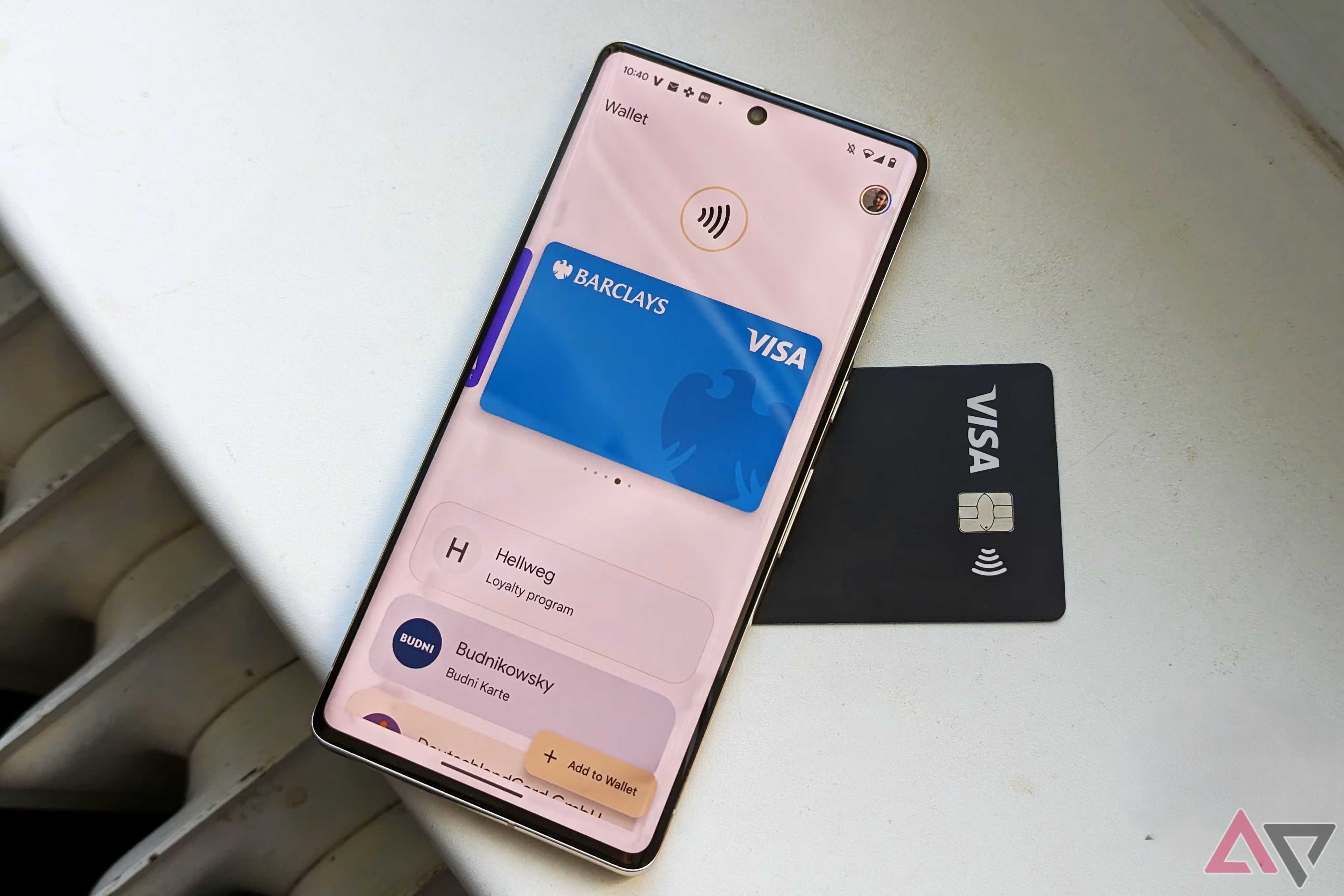 Google Wallet open on a Google Pixel phone resting on top of a black Visa card.