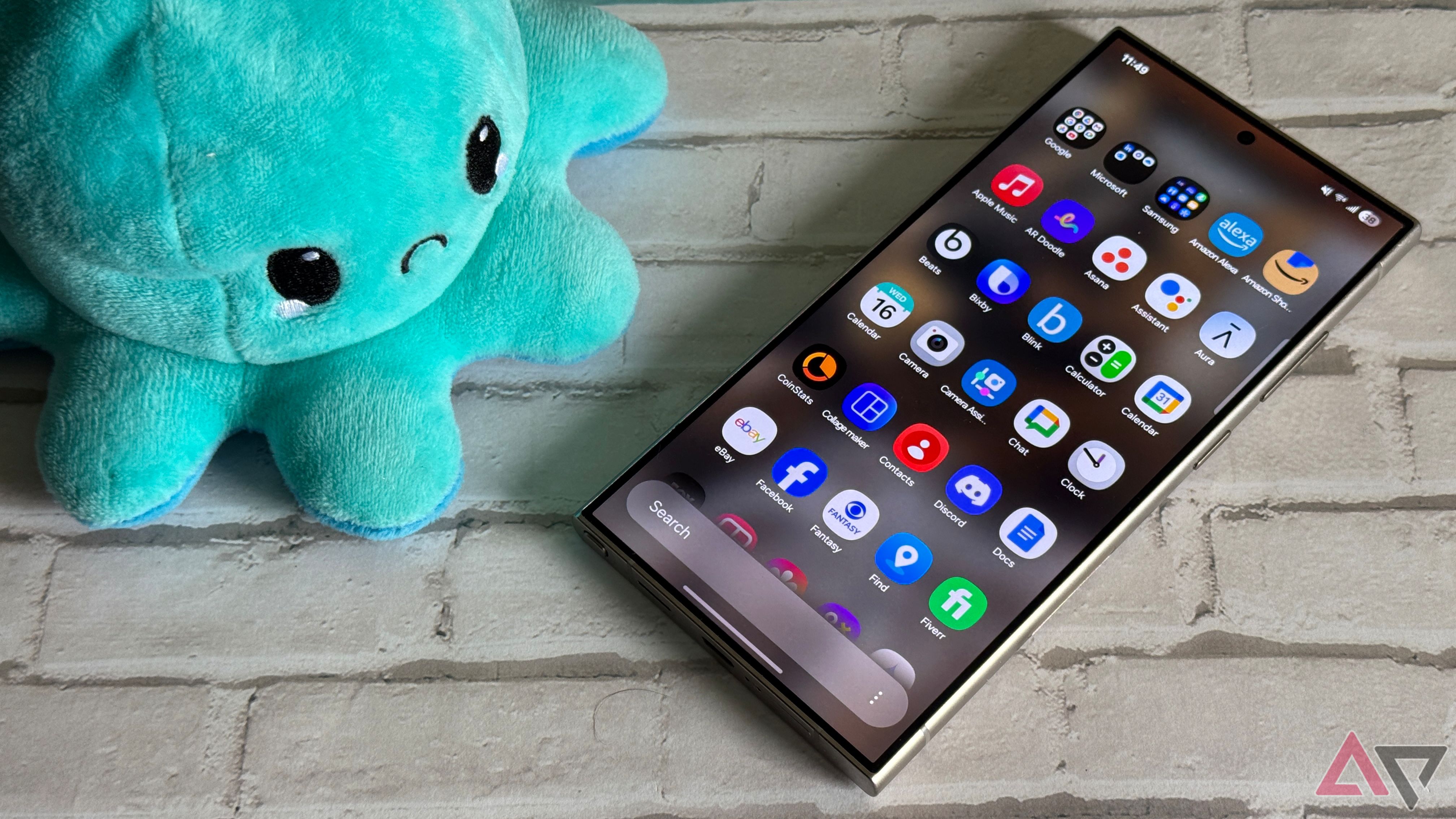 Samsung Galaxy S24 Ultra running One UI 7 with a frowning plush