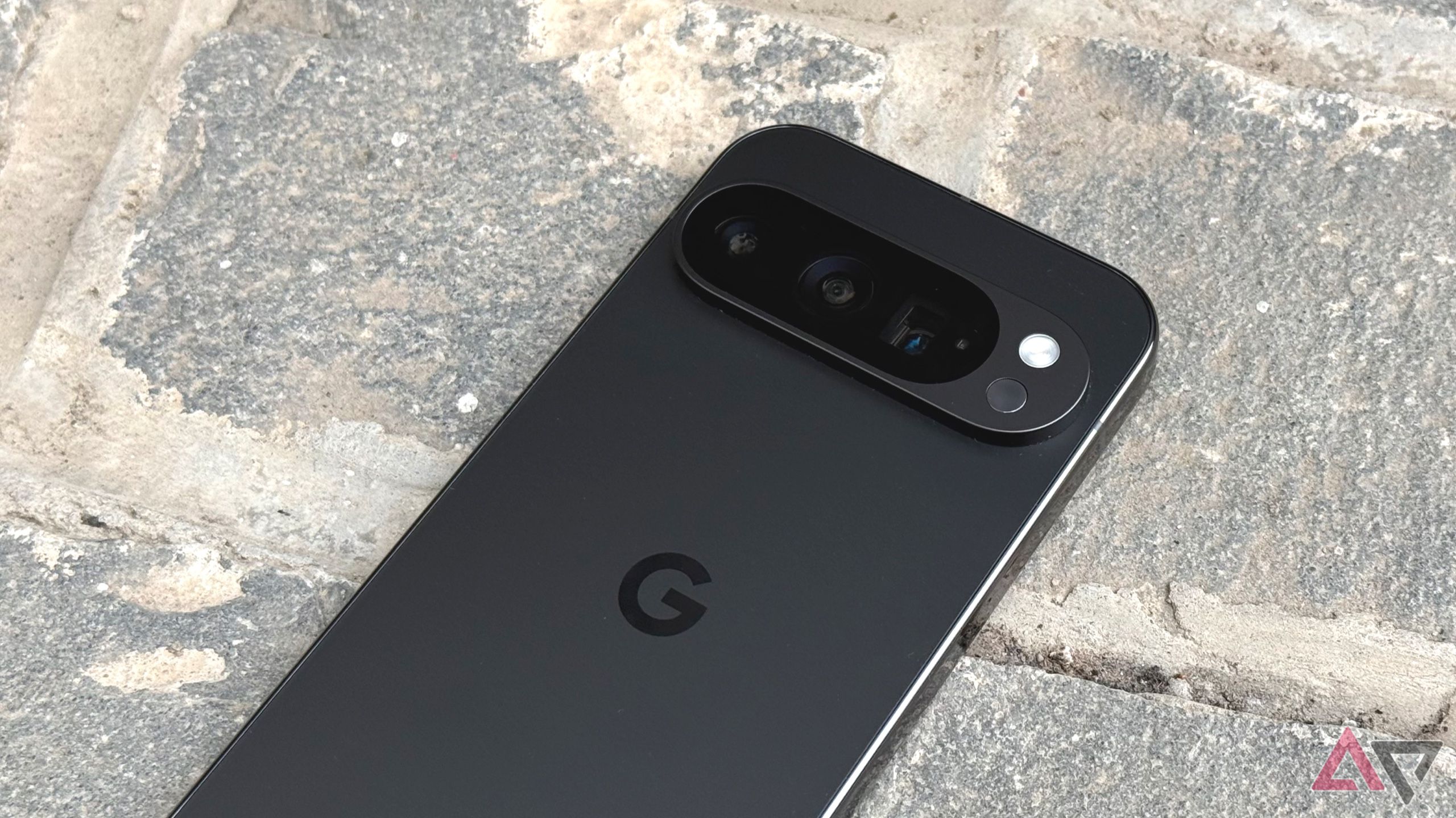 Pixel 9 Pro lying on a stone bench
