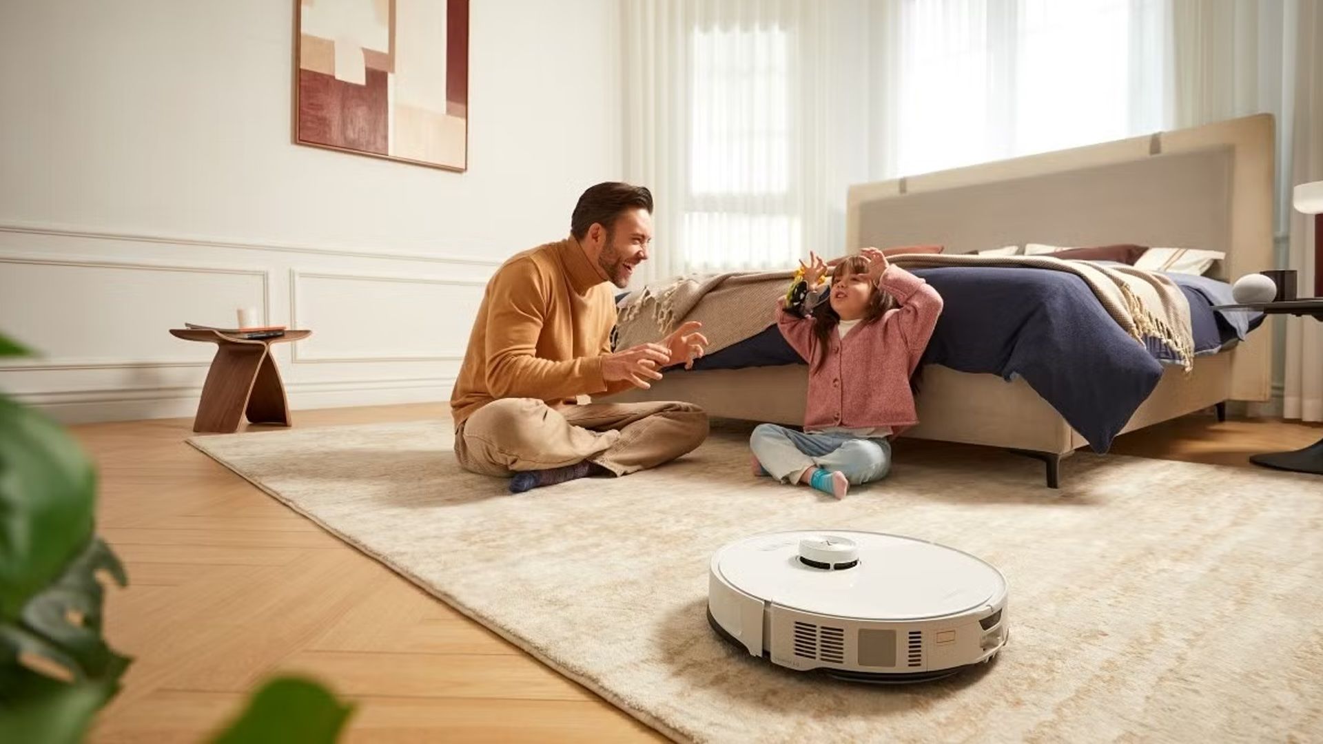 The Roborock S8 MaxV Ultra cleans in the foreground while a family plays behind it.