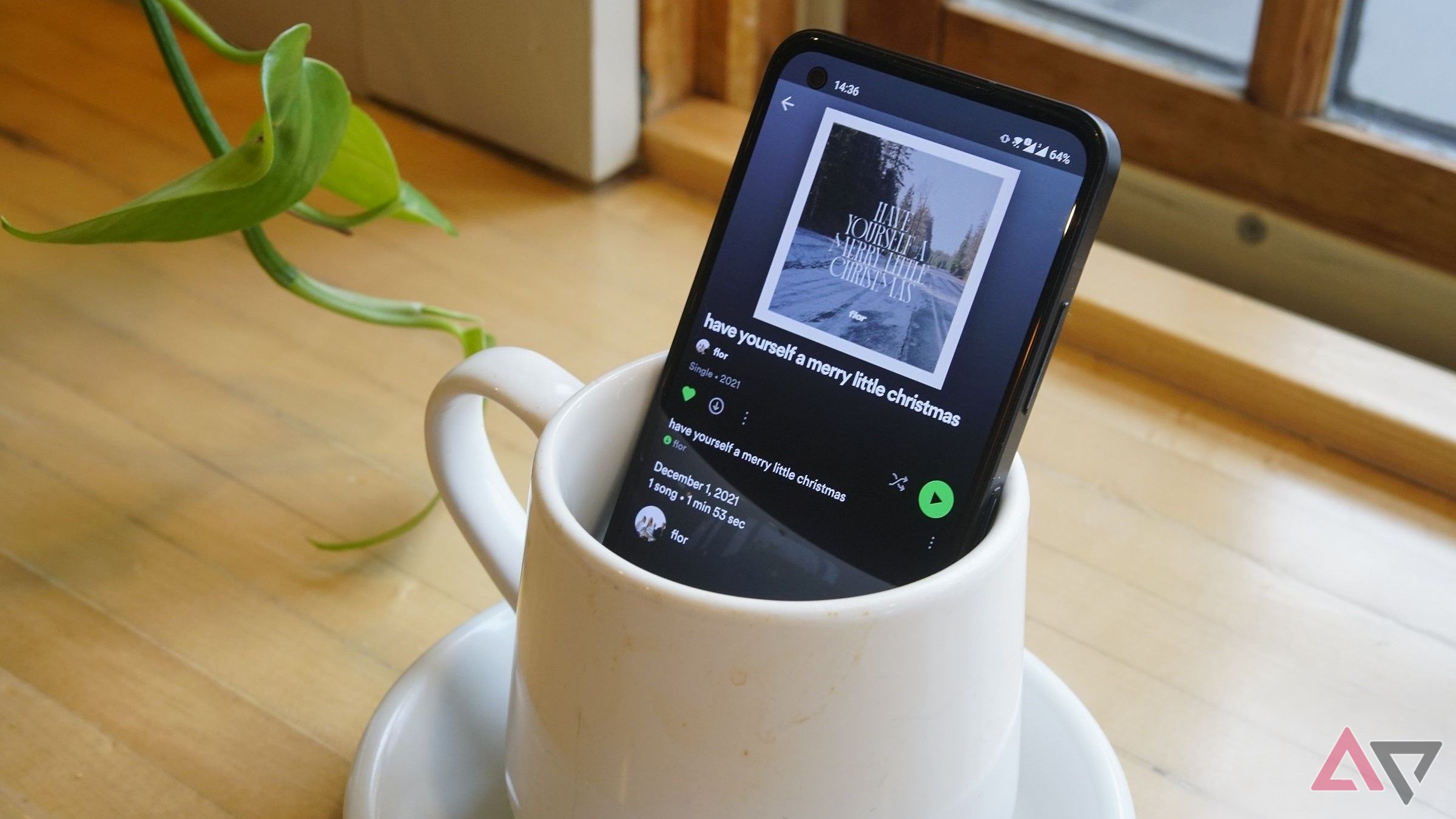 spotify on phone screen as phoe sits in coffee cup