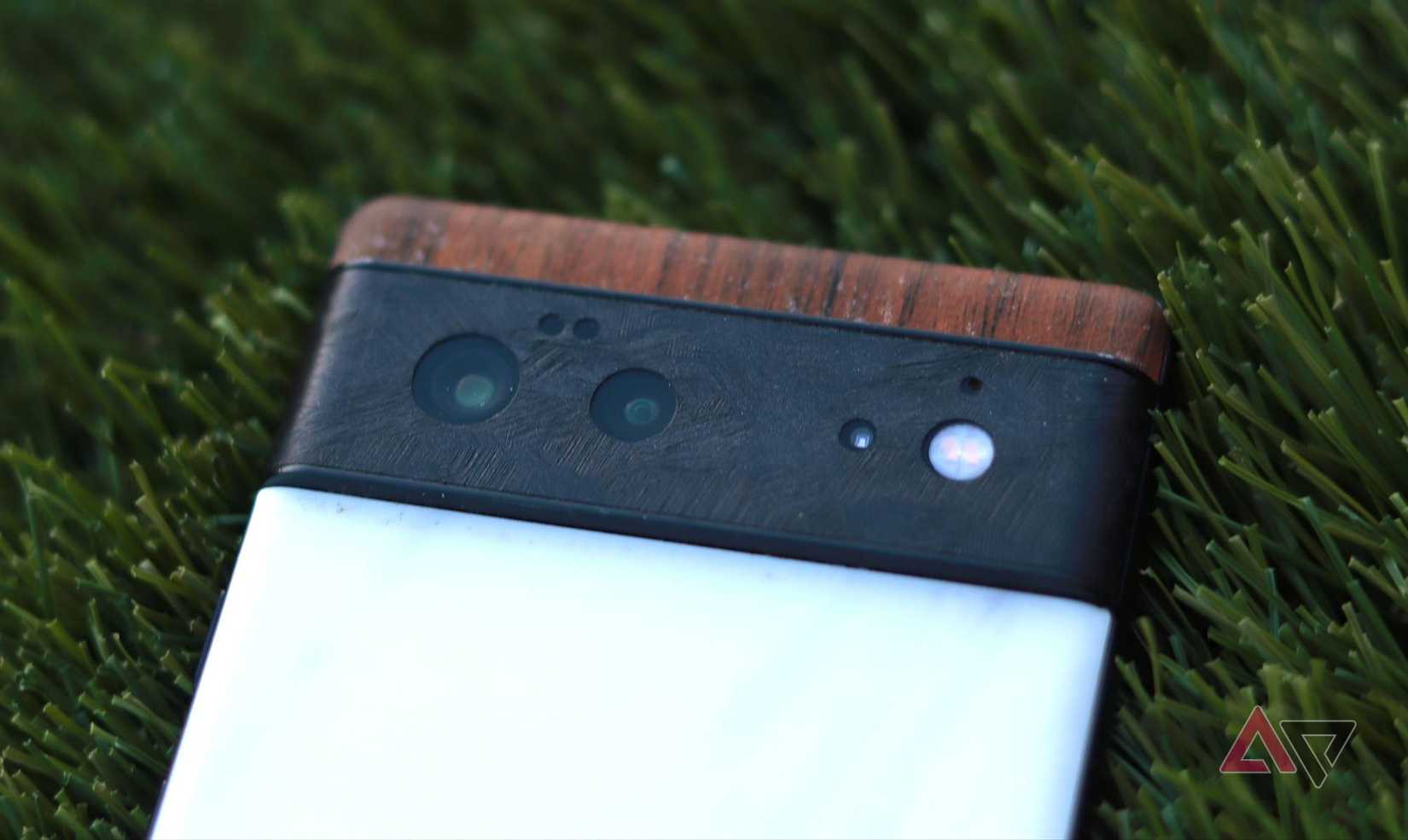 The Google Pixel 9 Pro sitting screen-up on a green rug. 