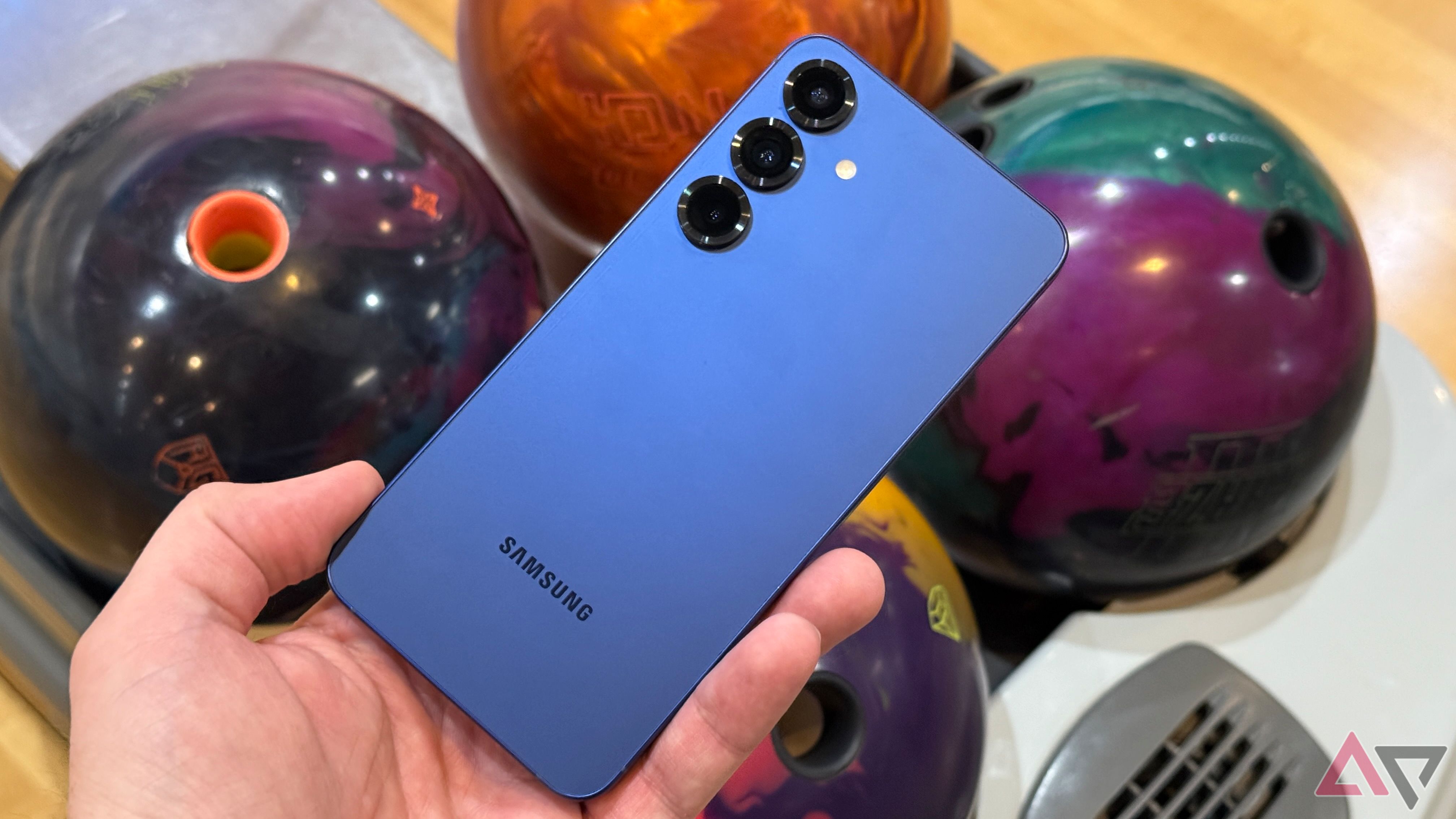 Samsung Galaxy S25+ held up against bowling balls