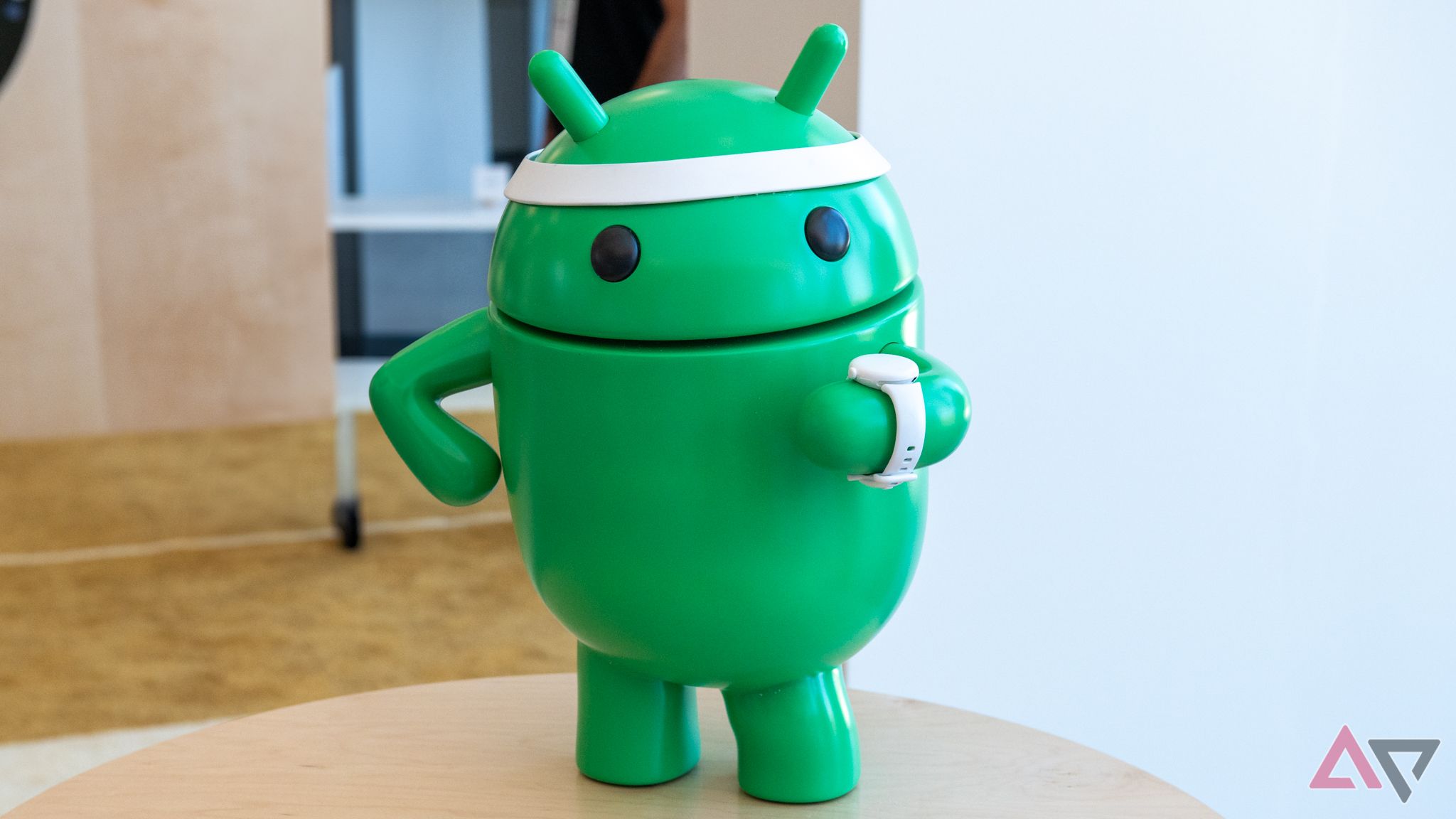 An Android bot character looking at its watch