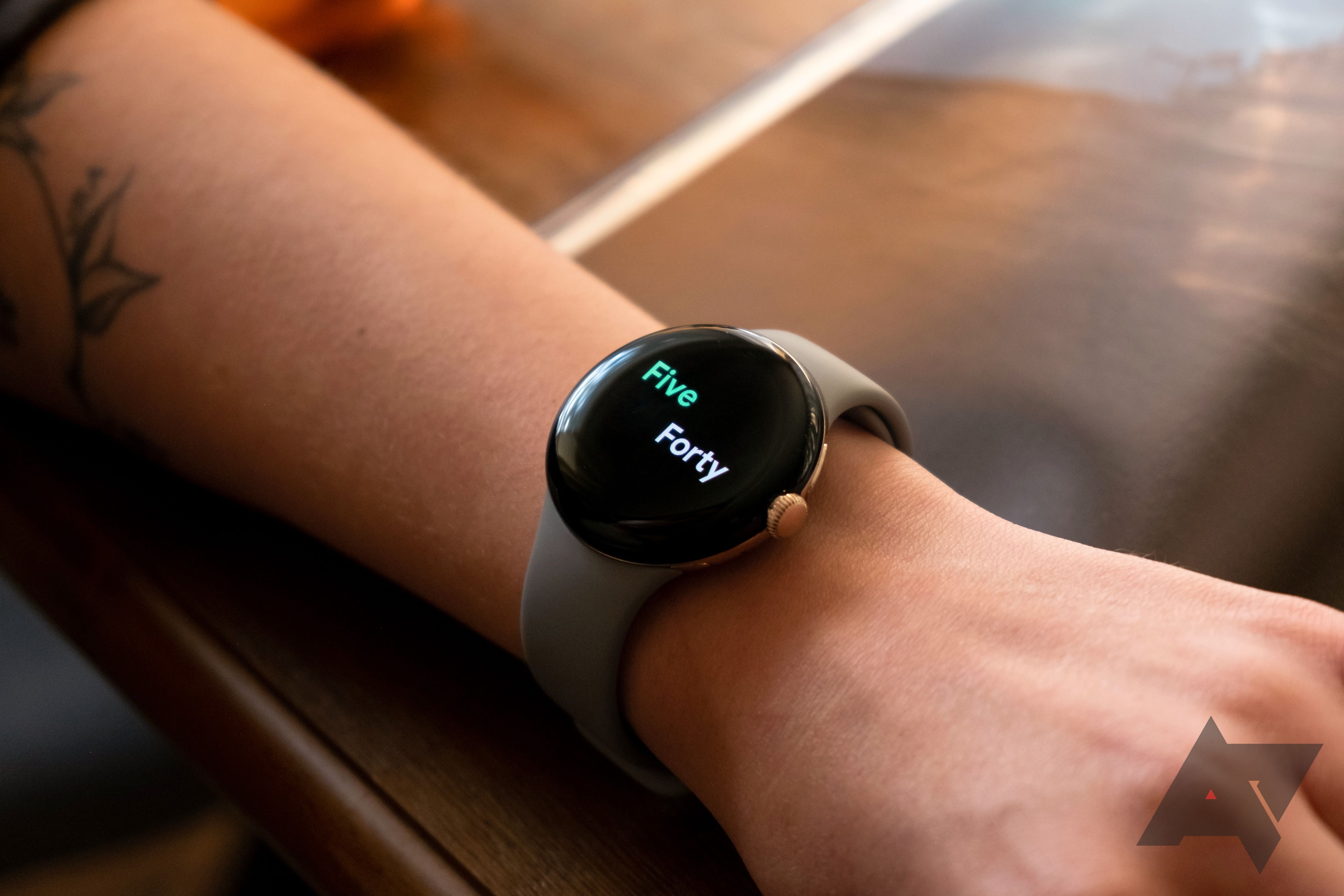 Google Pixel Watch on wrist showing the words