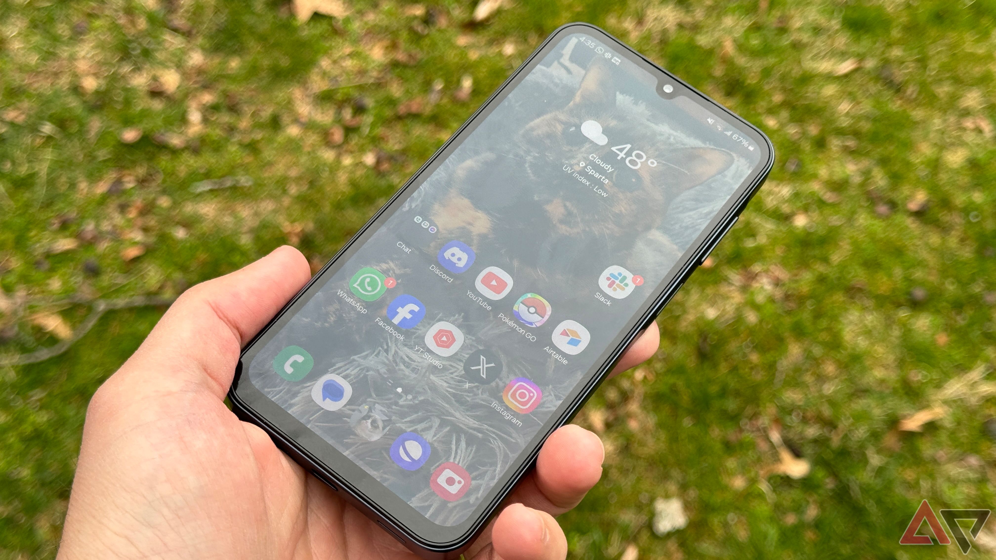 A person holds a Samsung Galaxy A15 in their left hand.