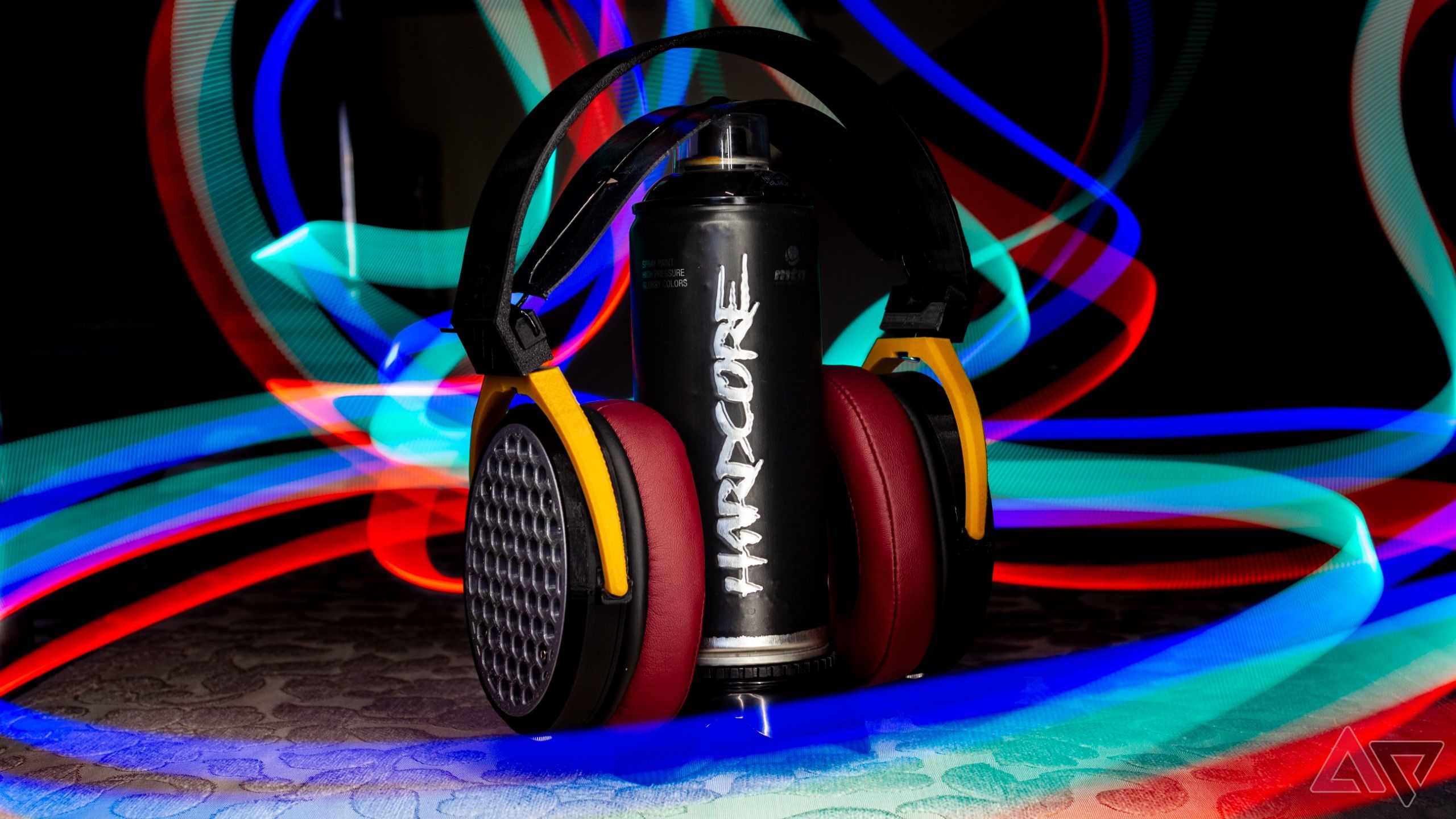 Open-back headphones on a Montana hardcore spray paint can in a light painting shot