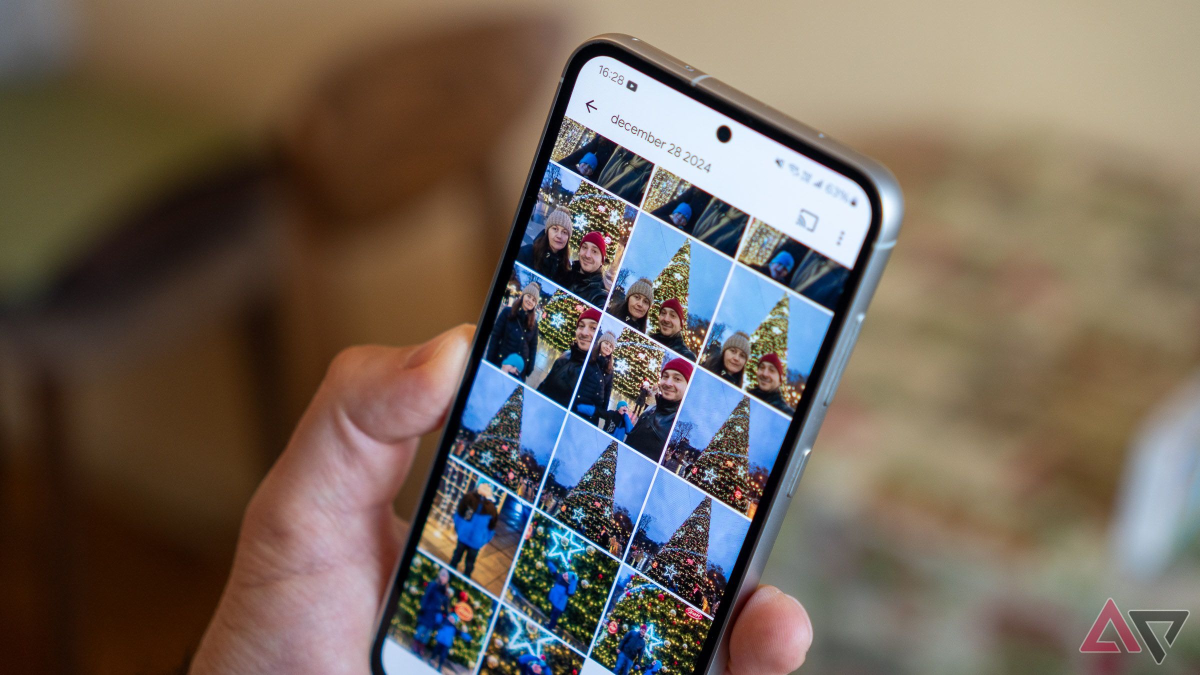 The Google Pixel 9a standing upright in a park, with the purple back showing towards the camera.