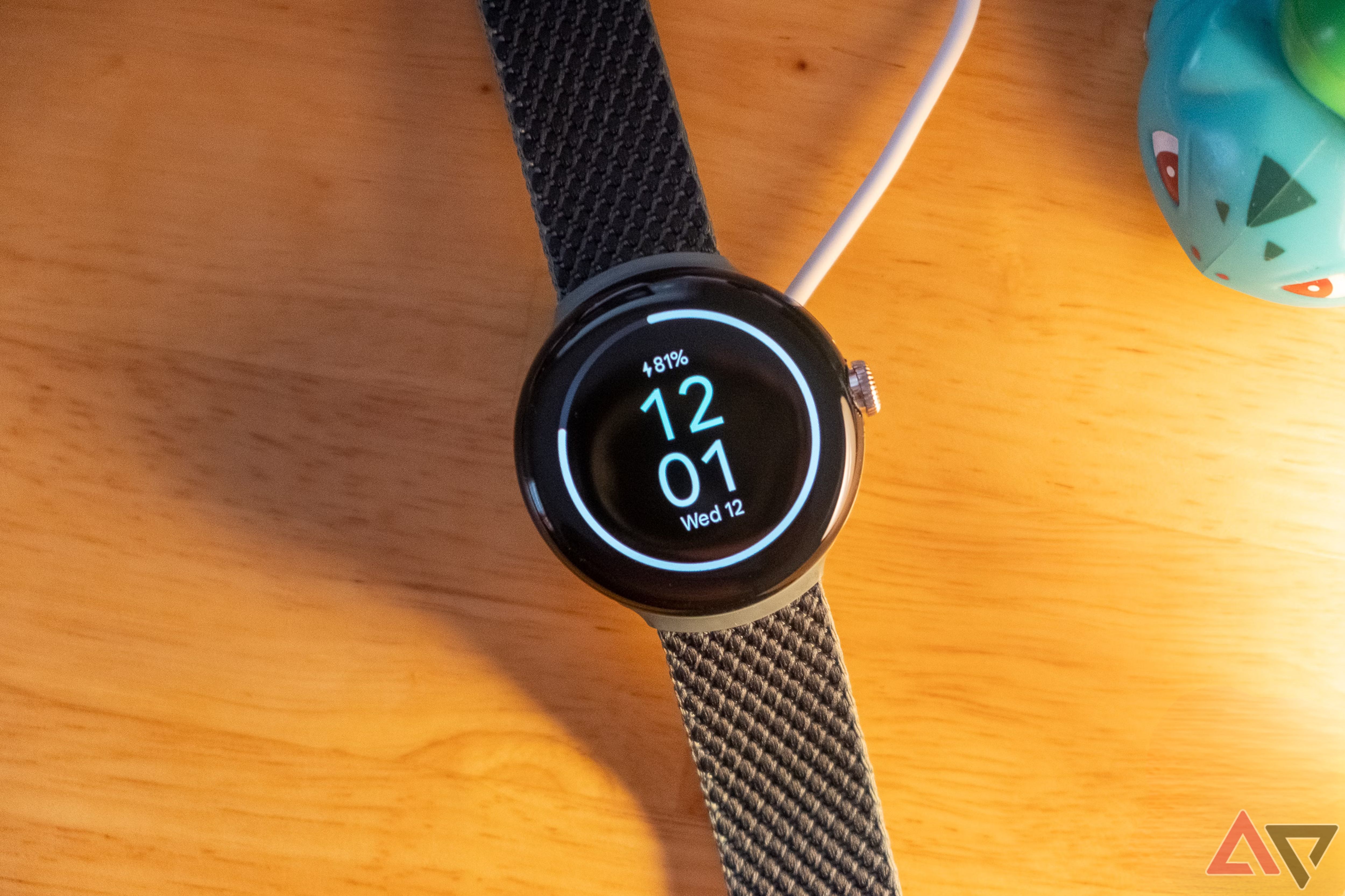 Google Pixel Watch sitting on a charger